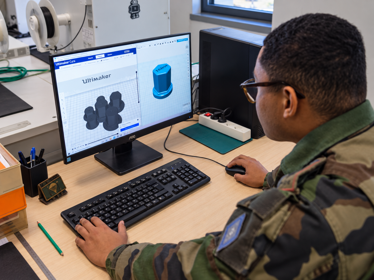 Technician preparing a custom protective cap model for 3D printing
